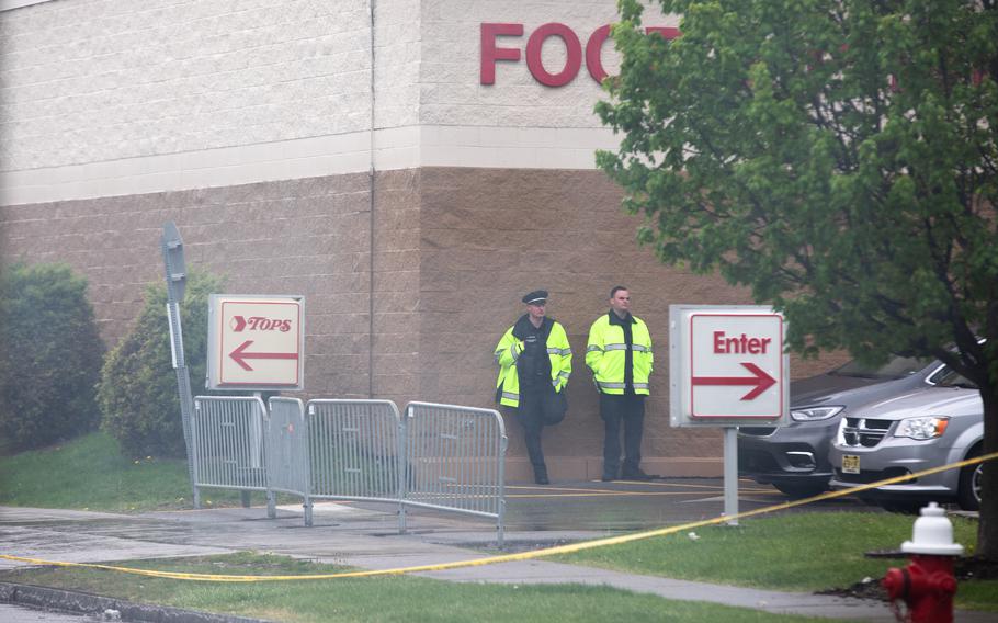 Police officers at Tops Friendly Market on Jefferson Avenue on Monday, where a gunman killed 10 people and wounded three others Saturday. Officials say the gunman was wearing body armor and military-style clothing.