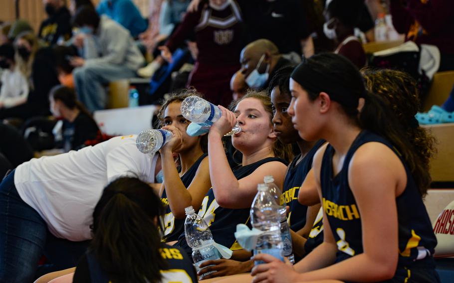 Players of the Ansbach Cougars grab a drink of water during the DODEA-Europe Division III girls basketball title game against the Lady Lions of AFNORTH in Kaiserslautern, Germany, on Saturday, Feb. 26, 2022.
