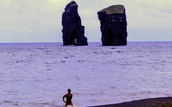 Lava rock formations rise out of the sea near the black-sand beach at Mosteiros on São Miguel. 
