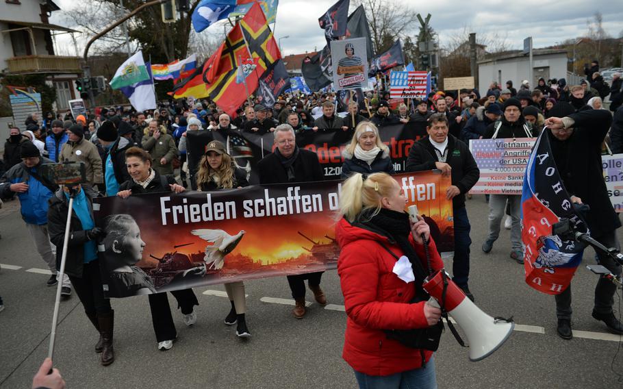 Pro-Russian peace protesters march through downtown Ramstein-Miesebach, Germany, on Sunday, Feb. 26, 2023. 