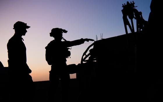 A rescue specialist gestures to a teammate about a simulated patient he is about to treat while an evaluator observes during a training exercise at Air Base 201, Agadez, Niger, Nov. 1, 2023. The joint training event included personnel from U.S. Special Operations and a personnel recovery team on location. (U.S. Air Force photo by Tech. Sgt. Rose Gudex)