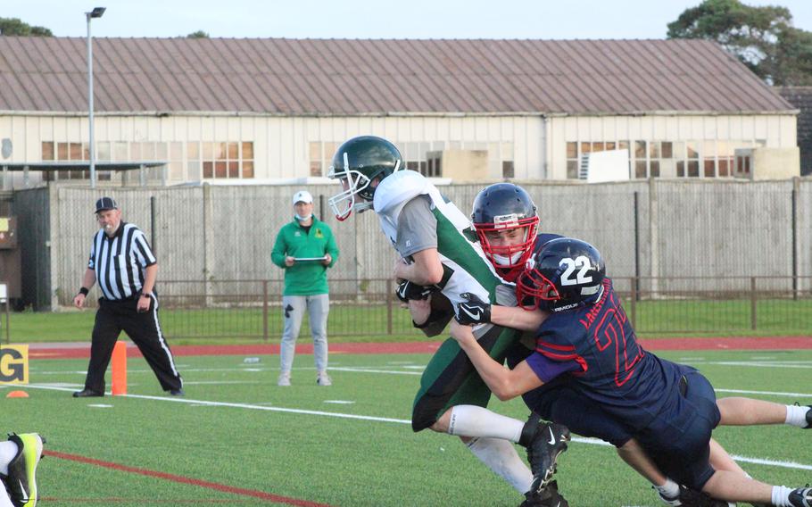 Alconbury running back Ezekiel Siegrist is handed the ball and tries to gain extra yards after contact with the Lancers’ defensive line. 