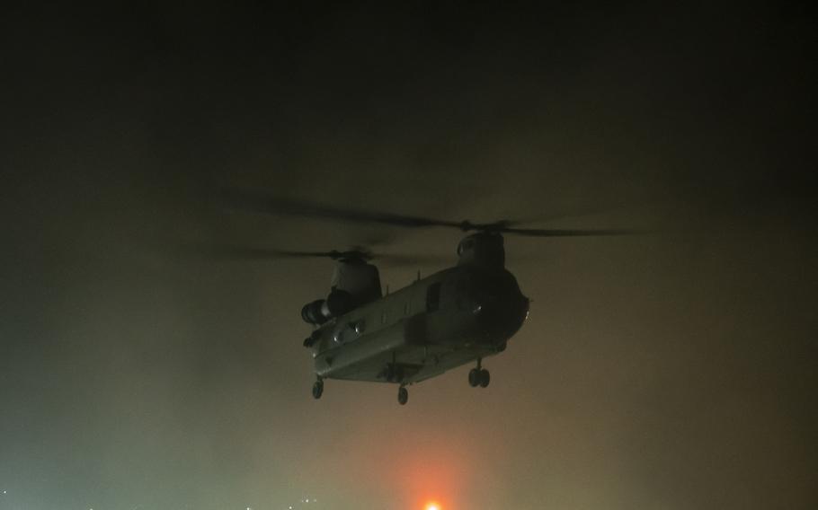 A helicopter carrying U.S. Embassy staff takes off from the embassy compound in Kabul, Afghanistan, in the early hours of Sunday, Aug. 15, 2021. Later that day, reports came in of the Taliban advancing on Kabul.