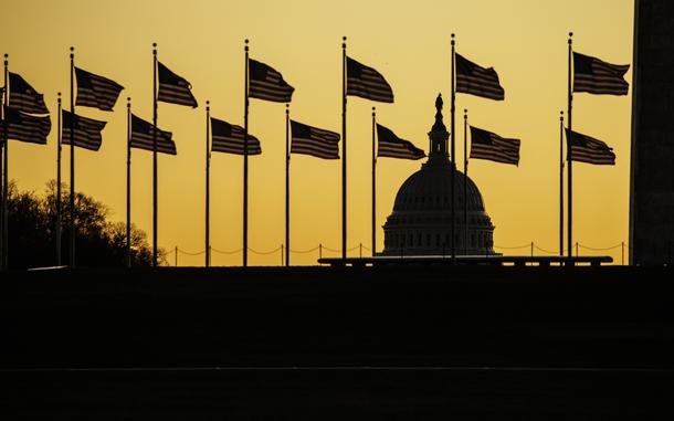 The U.S. Capitol dome is seen past the base of the Washington Monument as the sun rises on Nov. 9, 2022, in Washington, D.C.  (Samuel Corum/Getty Images/TNS)