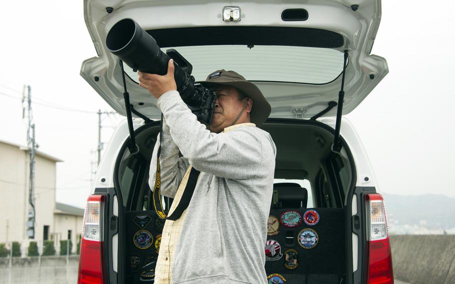 A tail spotter from Shunan city in Yamaguchi prefecture photographs aircraft taking off from Marine Corps Air Station Iwakuni, Japan, April 19, 2023. 