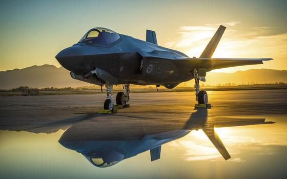 The sun sets behind an Australian F-35A Lighting II aircraft at Luke Air Force Base, Ariz., June 27, 2018. The first Australian F-35 arrived at Luke in December, 2014. Currently six Australian F-35's are assigned to the 61st Fighter Squadron where their pilots train alongside U.S. Air Force pilots. (U.S. Air Force photo by Staff Sgt. Jensen Stidham) Note: This image was created by placing a reflective surface in front of the the camera lens.