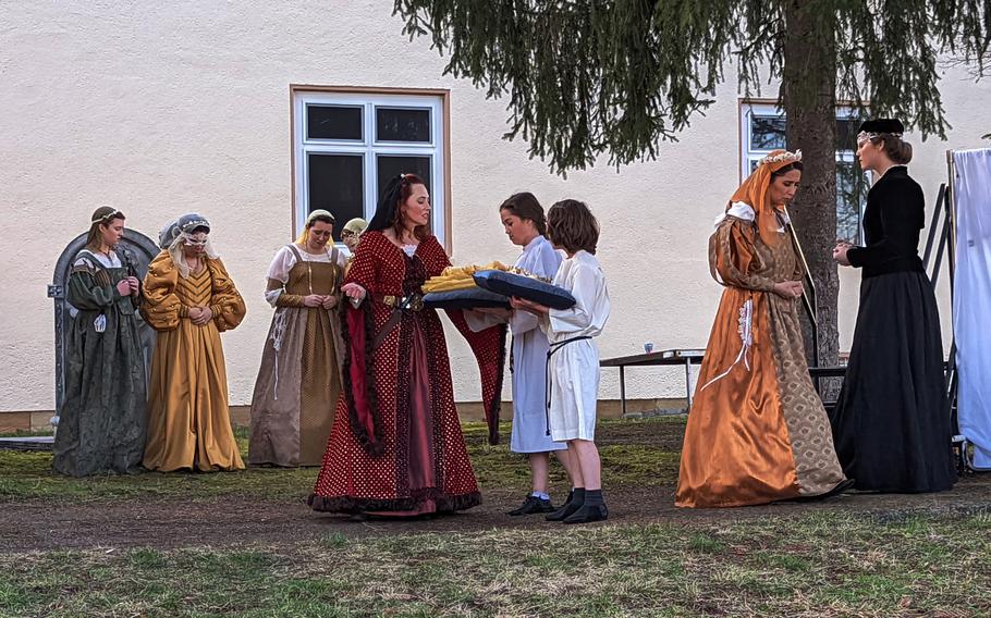 Actors with KMC Onstage perform a scene of "Medea" outside at Kleber Kaserne, Kaiserslautern, Germany, Feb. 14, 2022, after an equipment malfunction triggered the spinkler system, dousing the stage and equipment. 