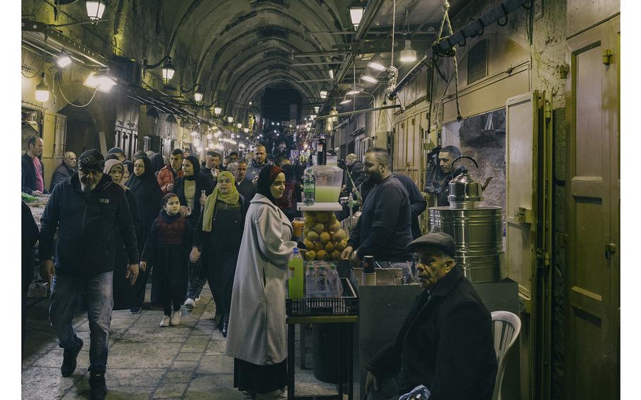 Palestinians walk through Jerusalem's Old City on March 11, 2024, after Taraweeh, the nightly Ramadan prayer. 