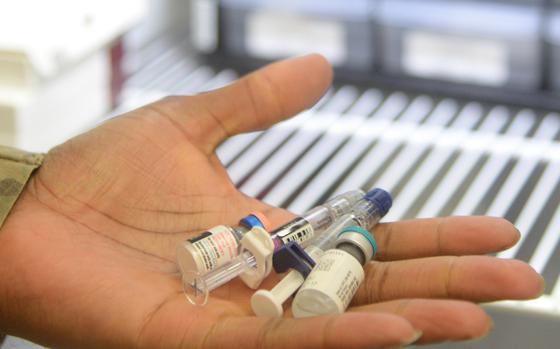 Medical personnel show commonly administered vaccines Aug. 2, 2019, at Malmstrom Air Force Base, Mont.  The most common vaccines are meningococcal conjugate vaccine to protect against meningitis and bloodstream infections, HPV vaccine for protection against cancers caused by HPV, Tdap and the seasonal flu vaccine. (U.S. Air Force photo by Airman 1st Class Tristan Truesdell)