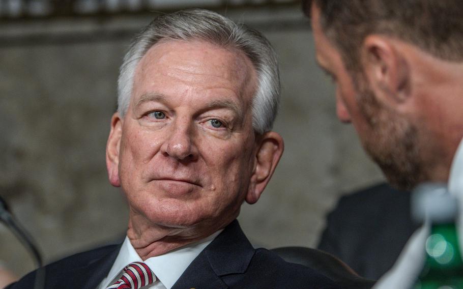 Sen. Tommy Tuberville, R-Ala., talks with a colleague during a Senate Armed Services Committee hearing July 12, 2023, in Washington.