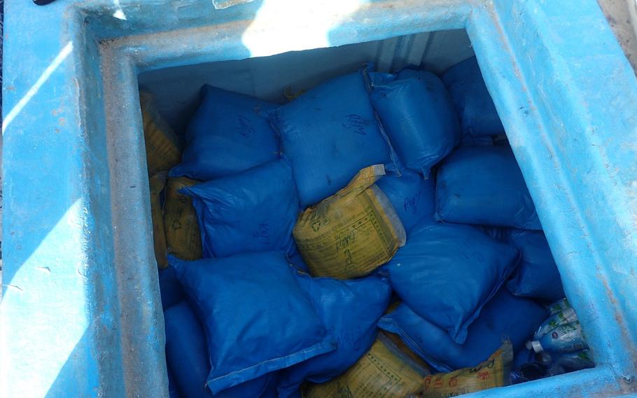 Bags of illegal narcotics sit in a storage compartment aboard a fishing vessel interdicted by crews of the USS Delbert D. Black in the Gulf of Oman on Sept. 28, 2022.