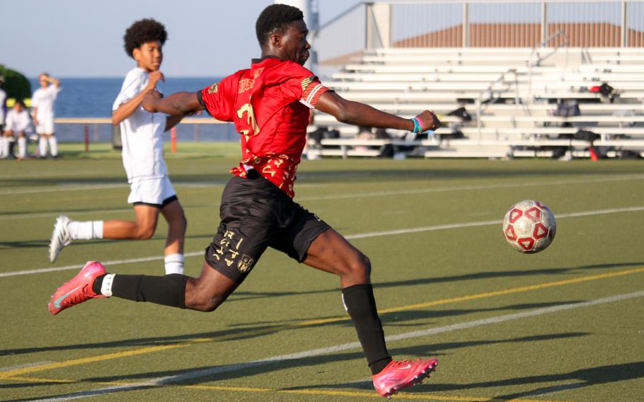 Koboyou Awesso kicks the ball.
