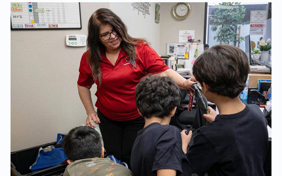 Cynthia Corral, a resource technician with Asian Resources Inc. Community Services, helps distribute backpacks to refugee children at the center in Citrus Heights, Calif.