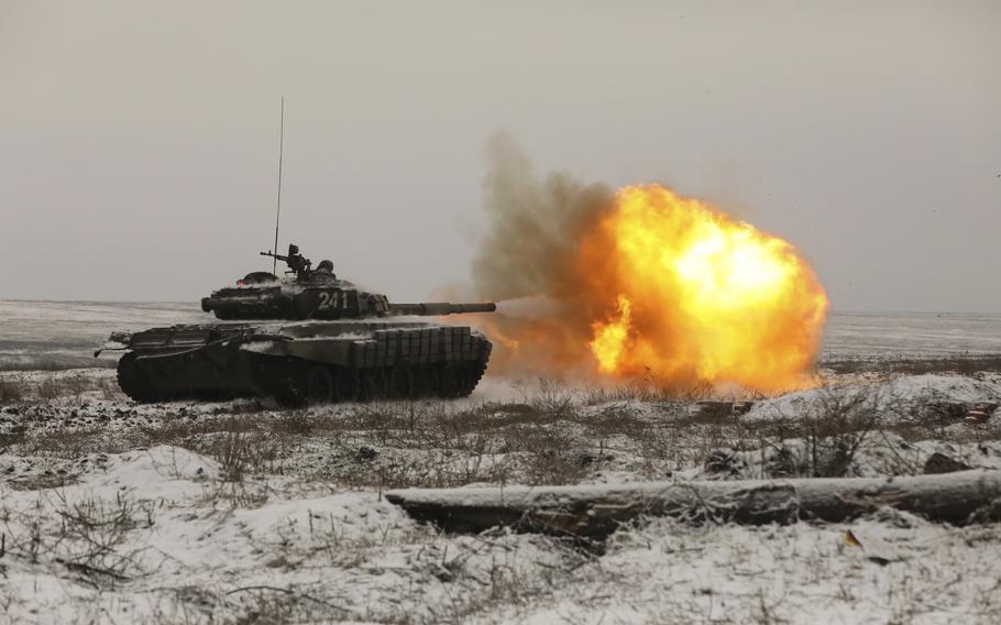 A Russian tank T-72B3 fires as troops take part in drills at the Kadamovskiy firing range in the Rostov region in southern Russia, Wednesday, Jan. 12, 2022. Russia has rejected Western complaints about its troop buildup near Ukraine, saying it deploys them wherever it deems necessary on its own territory.