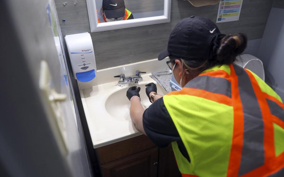 A Navy contractor collects a drinking water sample at Moanalua Preschool in Honolulu on Feb. 27, 2024.