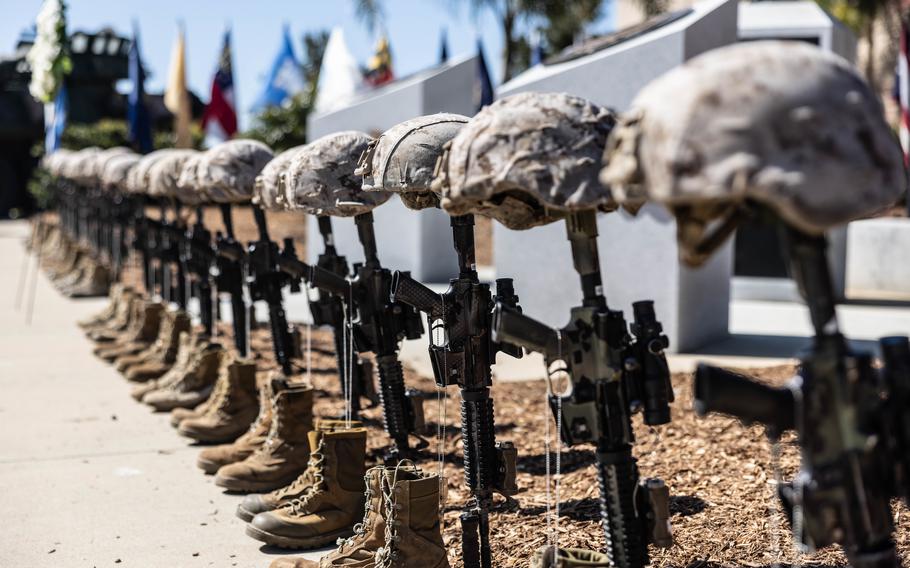 Battlefield crosses representing U.S. Marines from 1st Light Armored Reconnaissance Battalion, 1st Marine Division, who gave their lives during Operation Iraqi Freedom stand in front of a memorial during a 20th anniversary commemoration ceremony the battalion held at Marine Corps Base Camp Pendleton, Calif., March 18, 2023. 