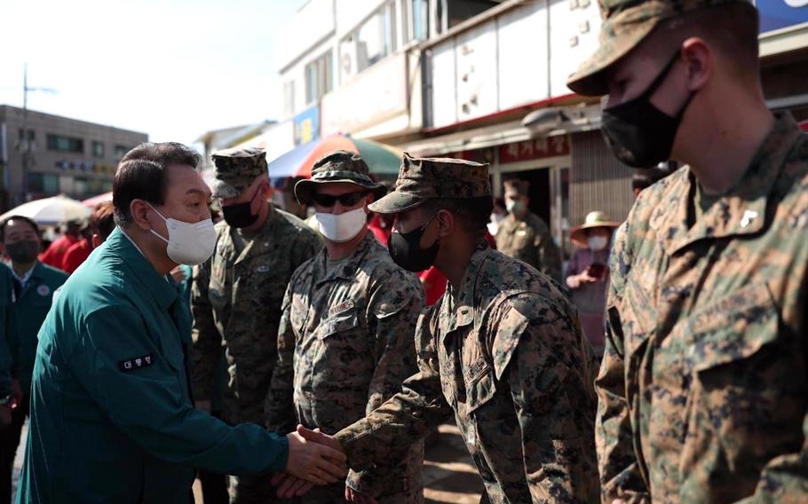 South Korean President Yoon Suk Yeol greets U.S. Marines taking part in Typhoon Hinnamnor cleanup efforts at Pohang's Ocheon Market, Wednesday, Sept. 7, 2022. 