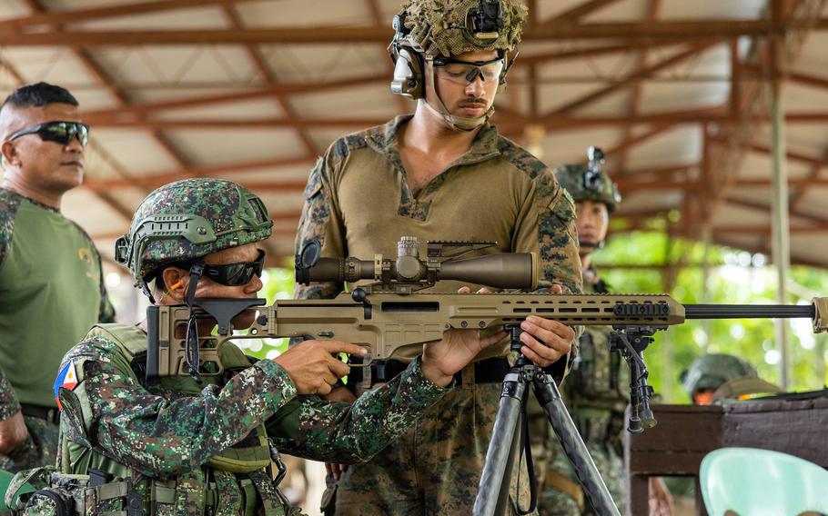 A Marine looks through the scope of a sniper rifle.