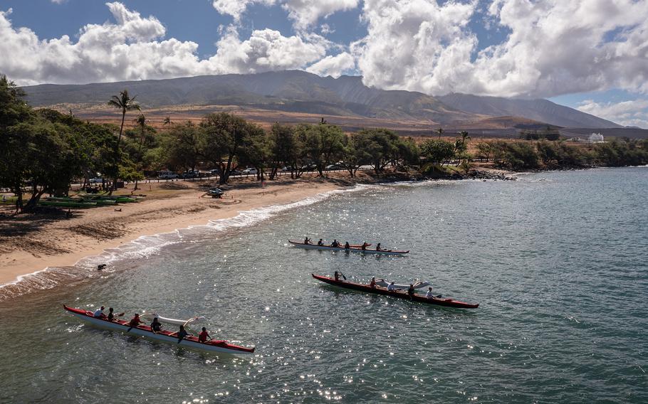 Members of the Lahaina Canoe Club paddle out from Hanakaoʻo Beach in honor of Carole Hartley, their member who died in the Aug. 8 fires in Lahaina, Hawaii. The outing on Monday was the first time the tightknit club members, many of whom lost their homes, had paddled together since the fires that destroyed much of Lahaina. 