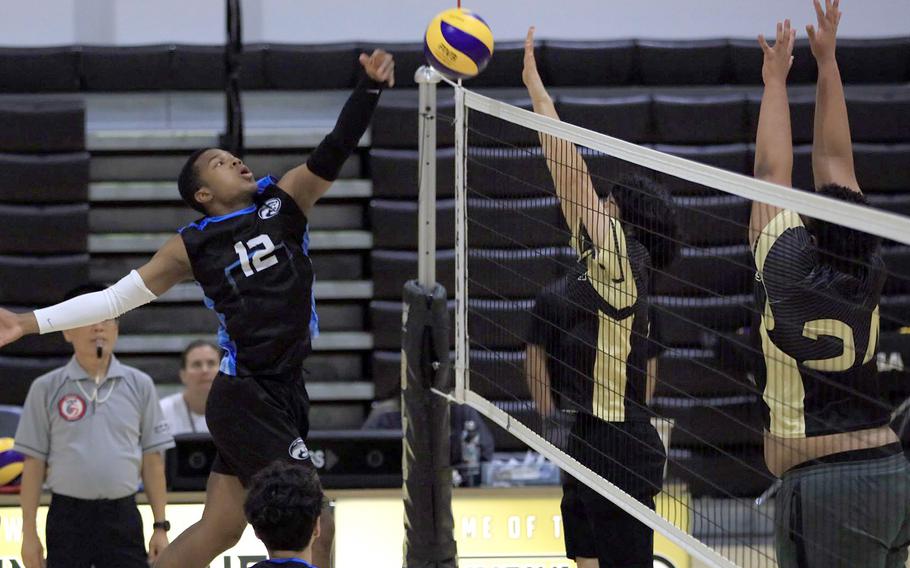 Osan's T'zuriel Jennings taps the ball over tne net against Humphreys during Saturday's DODEA-Korea boys volleyball match. The Cougars won in five sets.