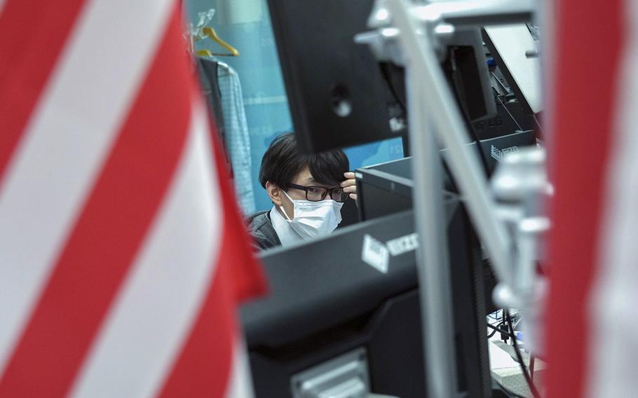 A dealer looks at monitors in the trading room at foreign exchange brokerage Gaitame.Com Co. in Tokyo on Oct. 20, 2022. 