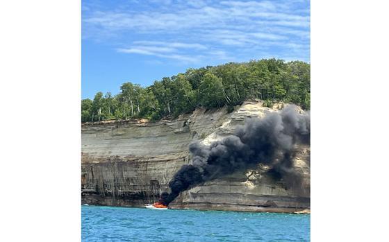 A U.S. Coast Guard crew rescued five people off a burning vessel July 29, 2023, at Pictured Rocks National Lakeshore in Munising, Mich.