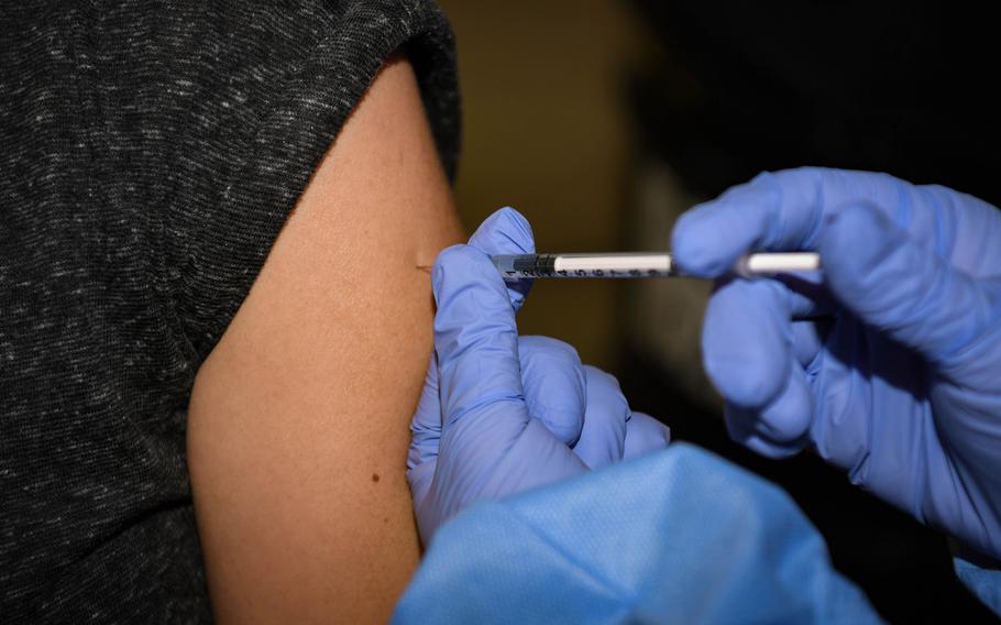 A COVID-19 booster shot is administered at Ramstein Air Base, Germany, Jan. 25, 2022. The Defense Health Agency has granted approval to give second booster shots to adults ages 50 and over, and younger people with certain underlying health conditions. 