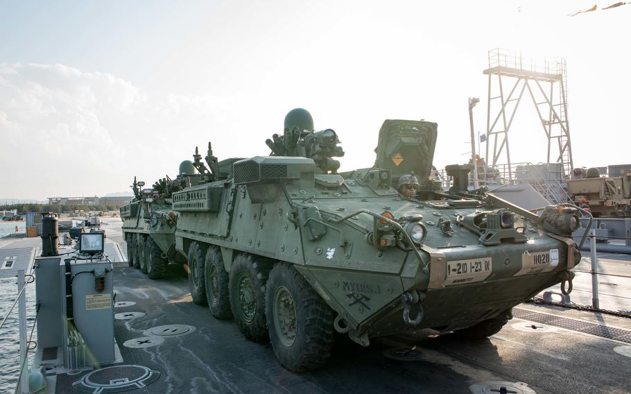 Sailors load Army Stryker infantry vehicles onto a ferry in South Korea during Operation Pacific Reach Exercise on April 15, 2017.