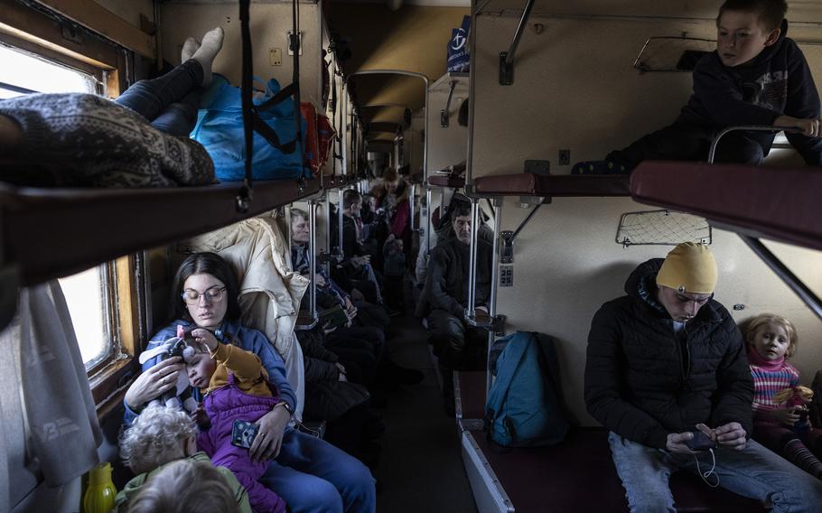 Ukrainian families on an evacuation train to Dnipro and Lviv on Feb. 10, 2023.