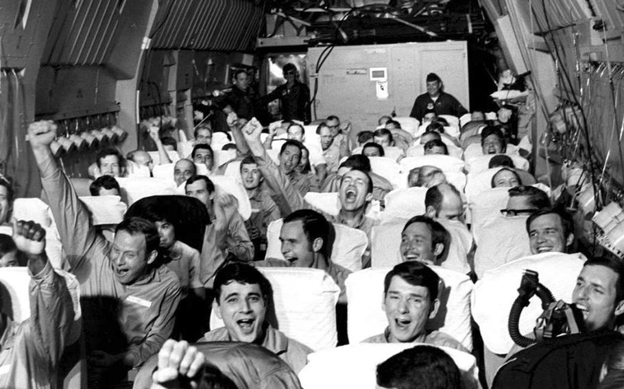 Newly freed POWs celebrate as their C-141A aircraft lifts off from Hanoi, North Vietnam, on Feb. 12, 1973, during Operation Homecoming. Some of the returning 591 POWs were flown to Westover Air Reserve Base in Chicopee, Mass.