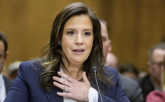 Stefanik lifts her hand to her chest while answering questions.