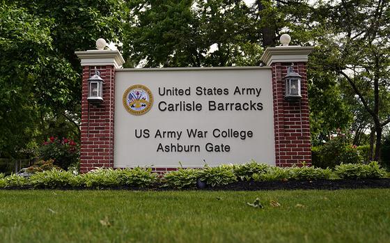 FILE - An entrance sign is seen outside the U.S. Army's Carlisle Barracks, Friday, June 10, 2022, in Carlisle, Pa.  The remains of five more Native American children who died at a notorious government-run boarding school in Pennsylvania more than a century ago will be disinterred from a small Army cemetery and returned to descendants, authorities said.  (AP Photo/Matt Slocum, File)
