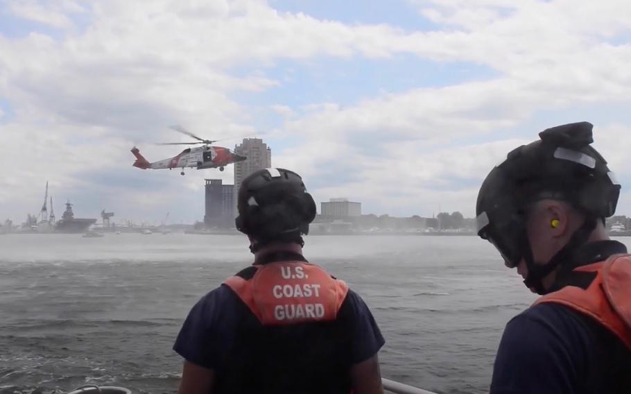 An Air Station Elizabeth City MH-60 Jayhawk helicopter crew works with a Coast Guard Station Portsmouth 45-foot response boat crew to perform a series of search-and-rescue demonstrations for attendees of Norfolk Harborfest. 