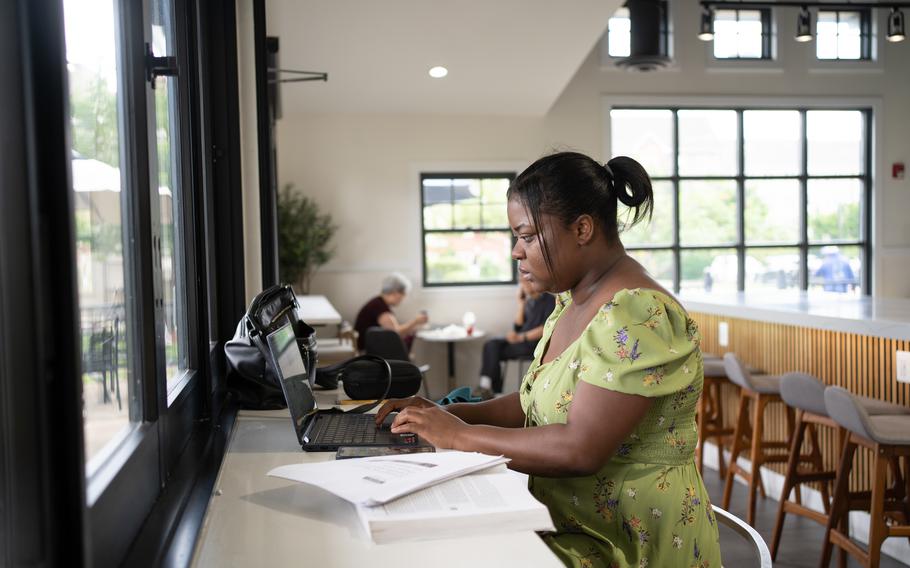 Nana Pokuaah studies for her cybersecurity classes at a local cafe in Chantilly, Va. 
