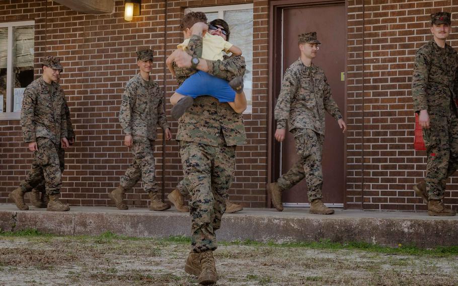 A U.S. Marine with the Combat Logistics Battalion 22, 26th Marine Expeditionary Unit (Special Operations Capable) reunites with his family at Camp Lejeune, N.C., Sunday, March 17, 2024.