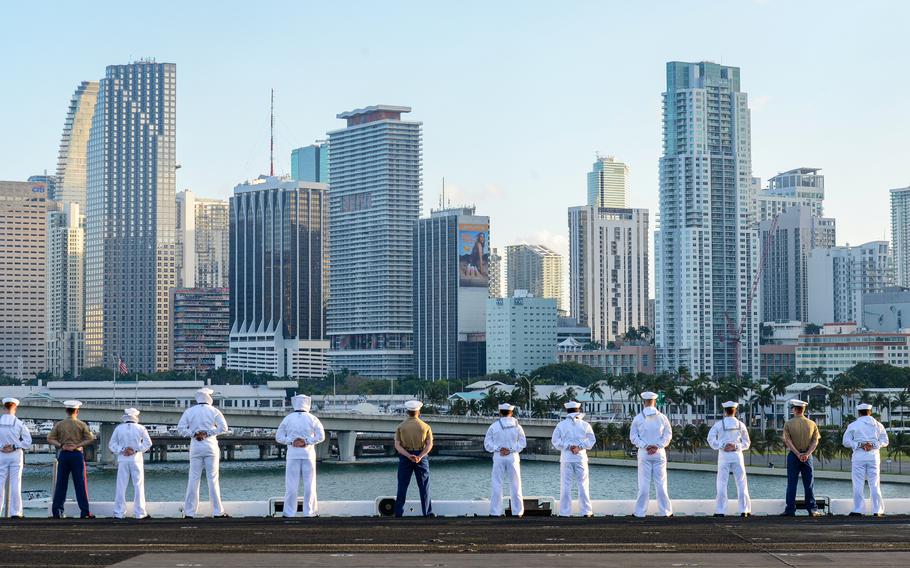 Sailors and Marines stand along the flight deck of the USS Bataan amphibious assault ship as it pulls into the port of Miami for Fleet Week on Sunday, May 5, 2024.