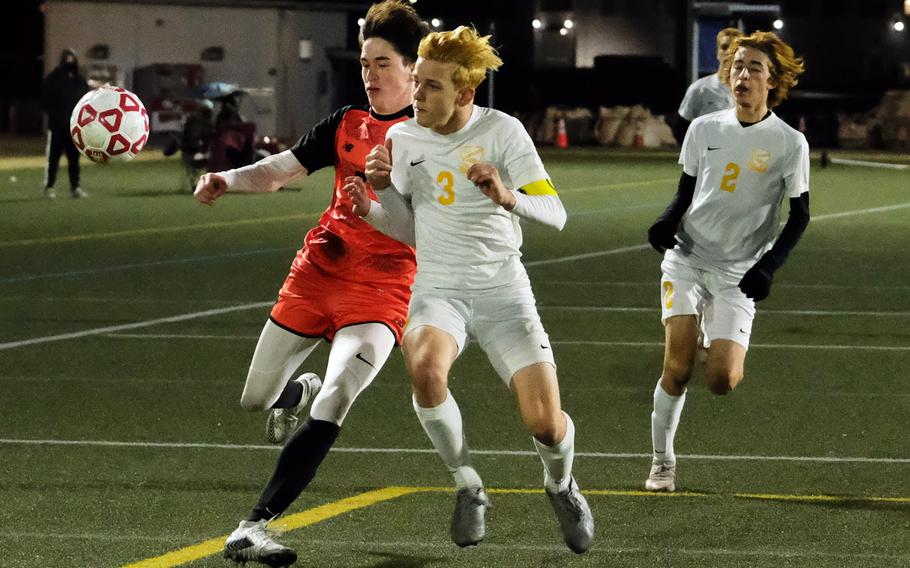 Nile C. Kinnick's Kou Nishiyama and Yokota's Caleb Jones chase the ball during Friday's DODEA-Japan soccer match. The Red Devils won 3-0.