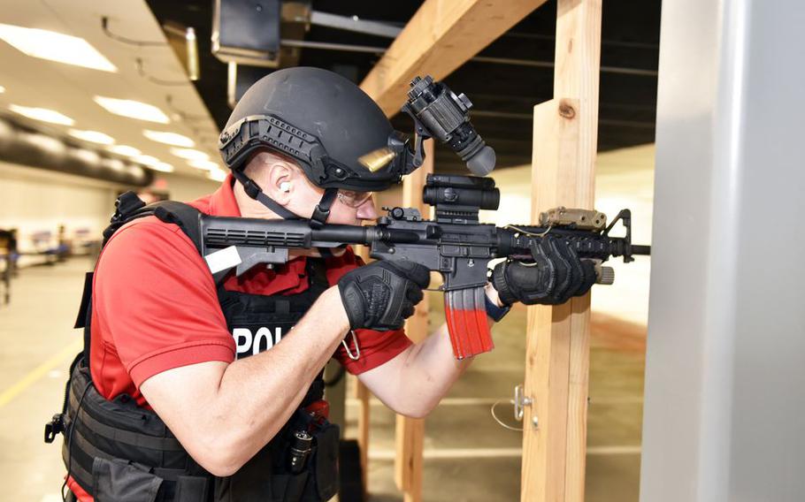 Combat firearms instructor James Hansen fires his weapon in the new Small-Arms Indoor range at Westover Air Reserve Base. Officials held a ribbon cutting ceremony for the new facility.
