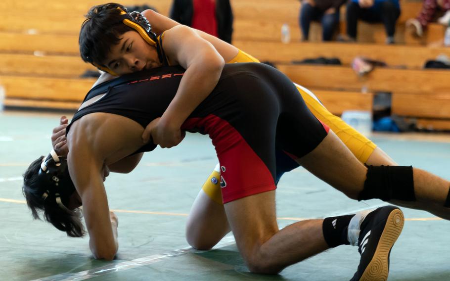 Yokota's Lane Lilly gains the upper hand on Nile C. Kinnick's Zavier Smith at 141 pounds during Saturday's DODEA-Japan wrestling tri-meet. Lily won by technical fall, but the Red Devils took the dual meet 49-8.