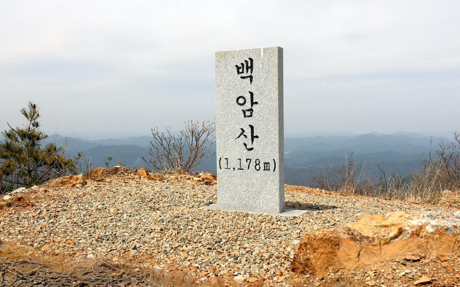 A marker denotes the summit of Baegam Mountain at an altitude of 1,178 meters in Hwacheon County, South Korea, May 2, 2023.
