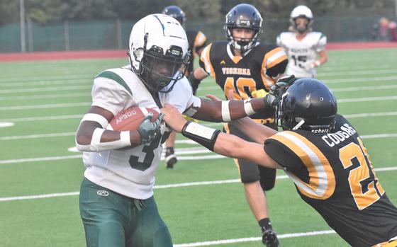 Naples' Robert Oliver, who rushed for a game-high 75 yards, stiff arms a Vicenza defender in the Wildcats' 40-0 victory over the Cougars on Friday, Sept. 22, 2023.