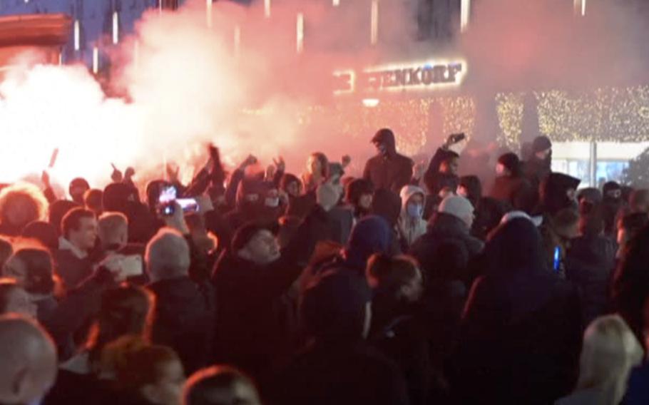 In this image taken from video, demonstrators protest against government restrictions due to the coronavirus pandemic, Friday, Nov. 19, 2021, in Rotterdam, Netherlands.