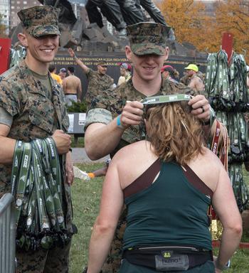 A runner receives a medal after finishing the 48th Marine Corps Marathon on Sunday, Oct. 29, 2023, in Arlington, Va.