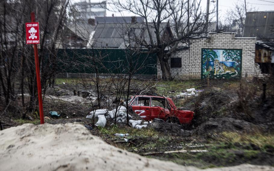 A sign warns of unexploded mines in Lyman, a city in Ukraine's Donetsk region, on Dec. 17, 2022.