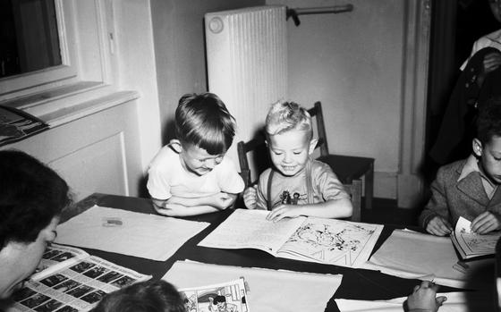 Johnny Walkmann (left) and Billy Feeman are old hands at picture books, even though it's only their first day in Kindergarten at the Heidelberg dependents' school on Aug. 9, 1948. 