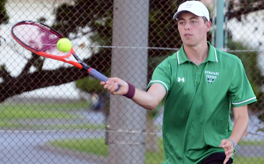 Kubasaki's Jacy Fisk strikes a forehand during Thursday's Okinawa tennis doubles matches. Fisk and partner Owen Ruksc beat Kadena's Maddux Fisk and Gabriel Fino 6-4.