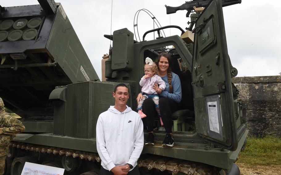 Spc. Christopher Rivera, a wheeled vehicle mechanic with the 41st Field Artillery Brigade, his daughter Olivia, and wife, Melanie Rivera, pose at the unit’s family day event at Grafenwoehr Training Area on Aug. 5, 2021.