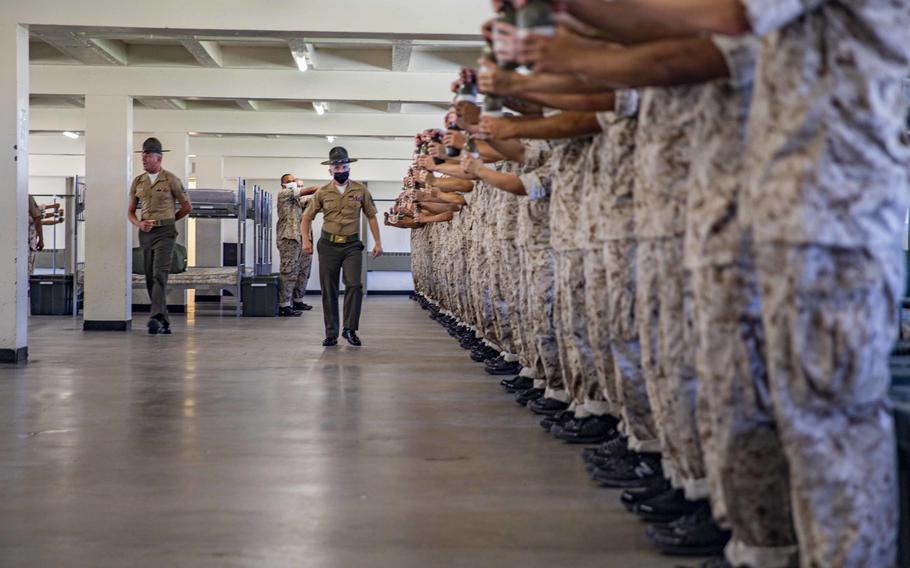 New U.S. Marine Corps recruits with Golf Company, 2nd Recruit Training Battalion, participate in the pick up process at Marine Corps Recruit Depot in San Diego, Oct. 29, 2021. 