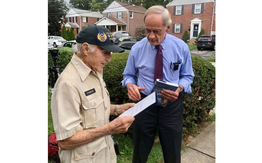 Sen. Tom Carper presents about-to-be 100-year-old World War II veteran Ray Firmani with a letter signed by himself, Sen. Chris Coons and U.S. Rep. Lisa Blunt Rochester, on Sept. 17, 2021 in Elsemere, Del.