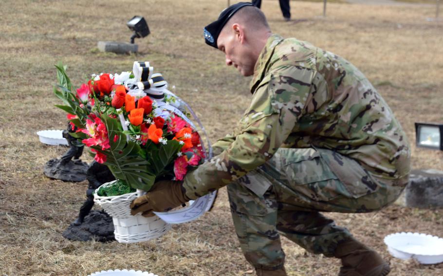 Army Brig. Gen. Mark Holler, Eighth Army’s deputy commander for operations, places flowers near a memorial for those who fought in the Battle of Bayonet Hill, at Osan Air Base, South Korea, Feb. 2, 2023. 